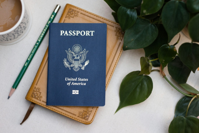 A blue colored passport on a diary