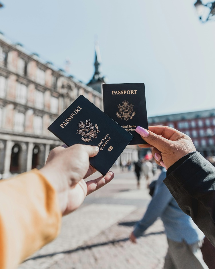 two individuals holding their passports